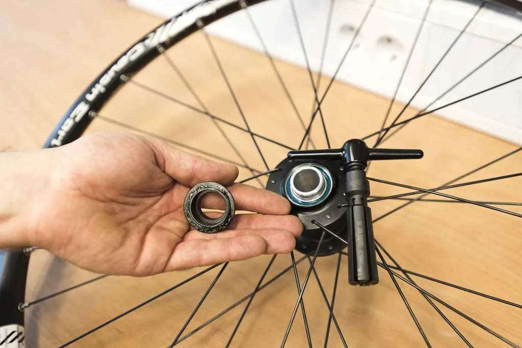 POV after shot of removing the a bicycle hub end cap with a Unior Hub Genie