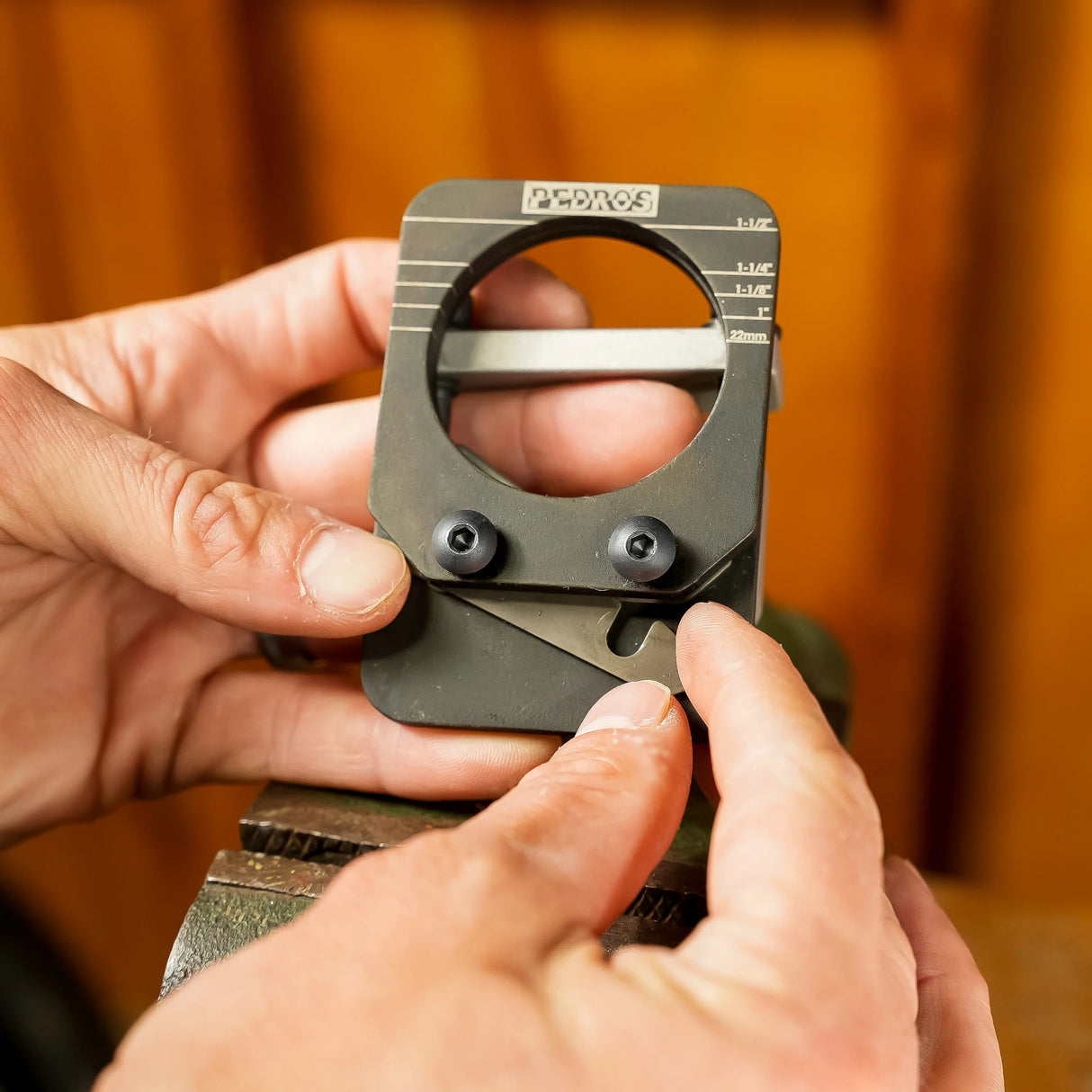 POV of hands adjusting the blade gap with shims on the Pedro's Pro Saw Guide