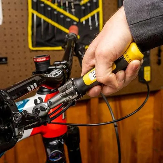 Pedro's Crowfoot Pedal Wrench being used with a Pedro's Torque wrench to torque the olive compression nut on a TRP brake lever