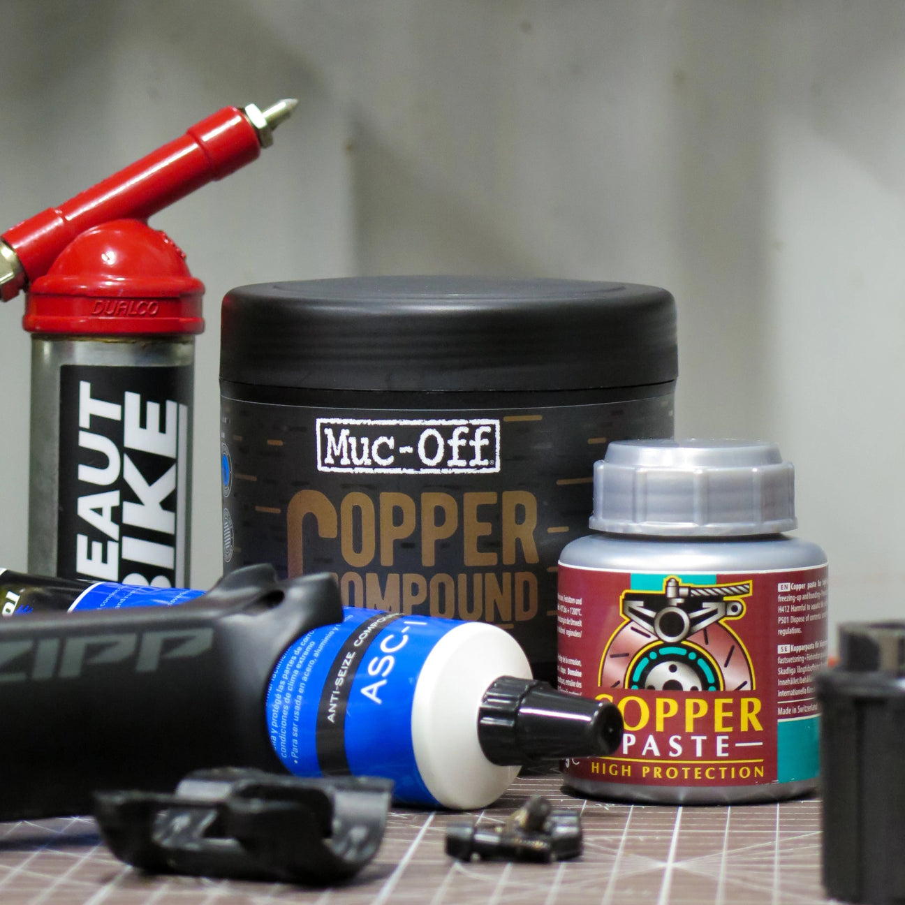 Park Tool ASC-1, Muc Off and Motorex Copper Pastes laid on on a work bench