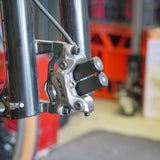 Side view of Dual Sumart UBB-20 /  Beaut Bike Piston Press being used on a 4 Piston Caliper